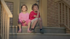 Pair of children boy with little girl sit on the porch [44740390] | 写真素材・ストックフォトのアフロ
