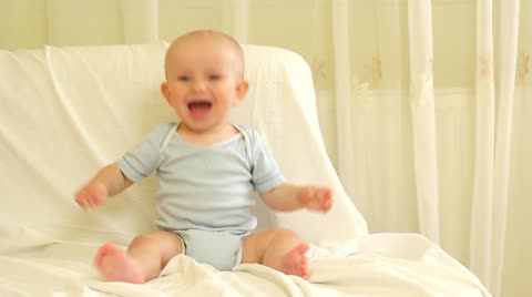 Adorable baby laughing and clapping hands