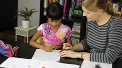 Homeschool Mom Teaching Spelling Lesson To Asian Daughter [45566261] | 写真素材・ストックフォトのアフロ