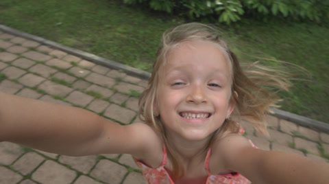 Portrait Spinning Little Girl Playing, Smiling in Camera, Children at Playground