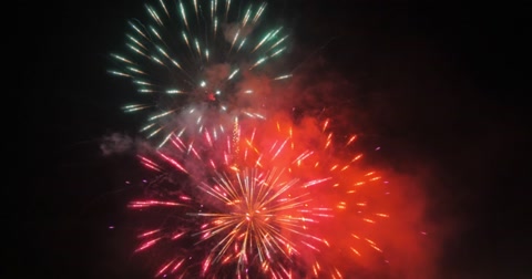 Beautiful colorful fireworks display over black sky background. 4K.