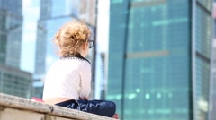 Back of little cute girl in glasses sitting on border [46536545] | 写真素材・ストックフォトのアフロ