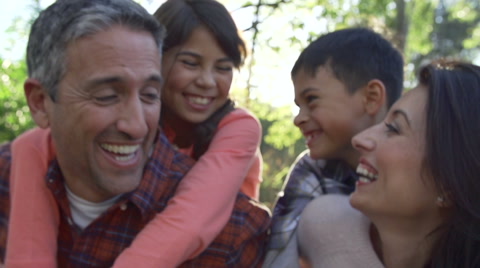 Slow Motion Sequence Of Parents Giving Children Piggyback