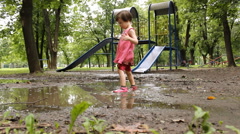 cute little girl playing in the puddle of mud [46776701] | 写真素材・ストックフォトのアフロ