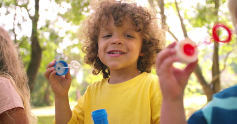 Kids playing with bubbles together having fun