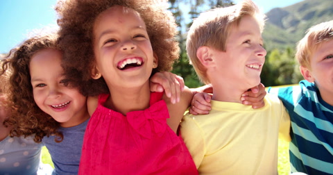 Mixed racial group of friendly children laughing together