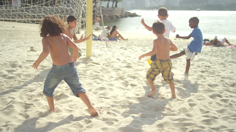 Kids playing soccer on a beach in Brazil