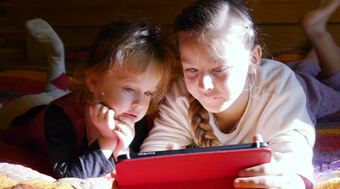 Children playing on tablet. Kids looking at computer