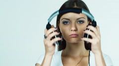 Attractive dark-haired girl puts on headphones and listening … [48362689] | 写真素材・ストックフォトのアフロ