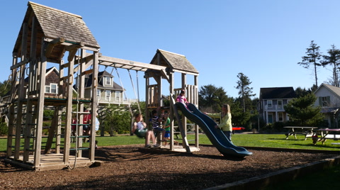 Family playing at park playground