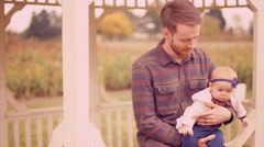 A young man playing with his baby daughter under a gazebo, [47894503] | 写真素材・ストックフォトのアフロ