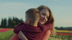Young teen girl holding little boy playfully in a field of … [47790162] | 写真素材・ストックフォトのアフロ