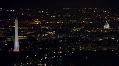 Over Washington DC cityscape at night, Washington Monument and Capitol in