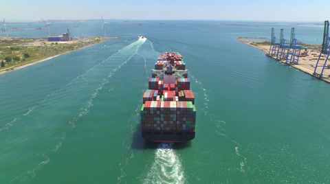 AERIAL: Container ship, loaded with shipping freight containers leaving port