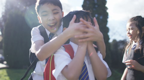 4K Happy young children playing outdoors in school playground