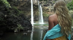 Young Island Girl Model Standing in Front of Waterfall in Tropical … [47240393] | 写真素材・ストックフォトのアフロ