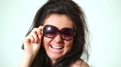 Dark-haired laughing girl model in dark sunglasses poses at … [47206170] | 写真素材・ストックフォトのアフロ
