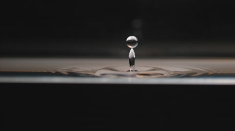 Extreme slow motion 4k, water drop splashes creating geometric ripples