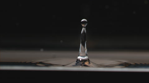 Extreme slow motion, water drop splashes and creates perfect geometric drips