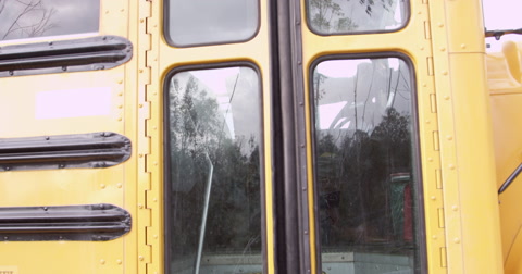 Young elementary school kids getting off a school bus