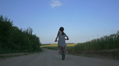 little cute girl rides a bike in the evening, back view, slow … [138495753] | 写真素材・ストックフォトのアフロ