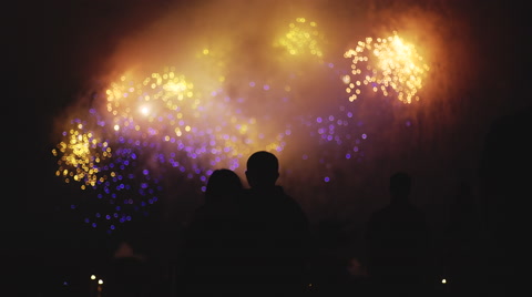 Unrecognizable people watching fireworks