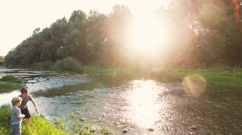 close aerial shot of two Kids playing at a river in wild nature