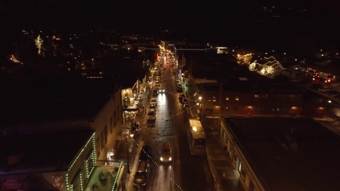 Aerial shot of small mountain town at night in the winter