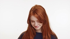 Shy coy ginger Caucasian teenage girl standing smiling on white … [45106288] | 写真素材・ストックフォトのアフロ
