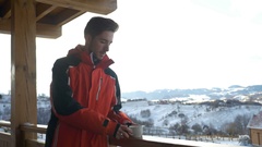 Guy grabbing a cup of hot beverage from a wooden railing on … [44947815] | 写真素材・ストックフォトのアフロ