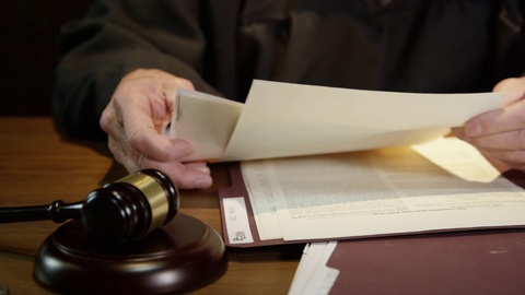 Judge going over documents in court