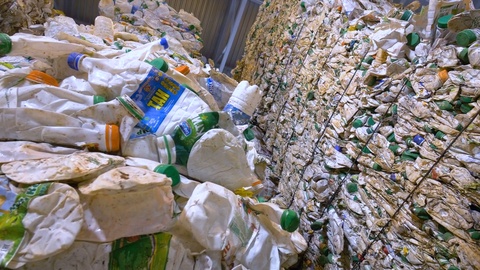 Piles of multicolor PET bottles in plastic recycling factory