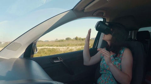 Girl a car rides around the city in the helmet of virtual reality. 360 VR Tec