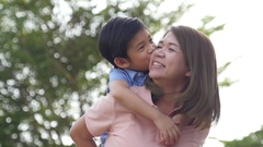 Asian child on a piggy back ride with her mother,slow motion [43523748] | 写真素材・ストックフォトのアフロ