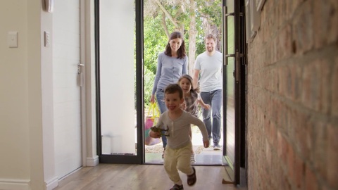 Excited Children Arriving Home With Parents