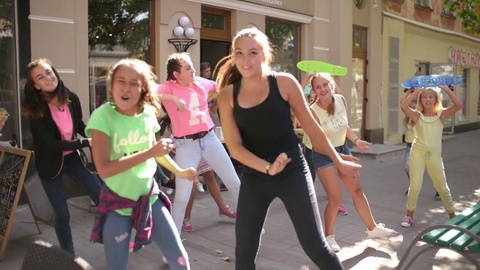 Happy Children dancing on the street near Ice Cream Shop