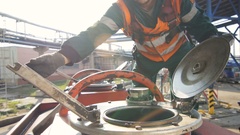 Closeup Skilled Worker Closes Cap on Reservoir and Makes Seal [138222213] | 写真素材・ストックフォトのアフロ