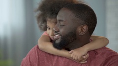 Cute girl hugging her dad around neck tightly with her little … [138178170] | 写真素材・ストックフォトのアフロ