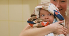 mother holding cute happy glad baby boy wrapped blanket bathing … [138141998] | 写真素材・ストックフォトのアフロ