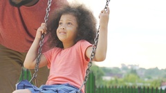 Young father gently swinging his little beautiful daughter … [138109227] | 写真素材・ストックフォトのアフロ
