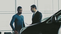 Young African man buying a car from a professional salesman [138098857] | 写真素材・ストックフォトのアフロ