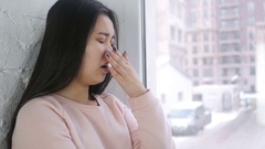 Young Asian Woman Yawning, Sitting at Window [137826120] | 写真素材・ストックフォトのアフロ