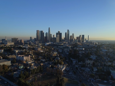 Cinematic urban aerial of downtown Los Angeles with city skyline and traffic