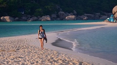 cute asian girl walks on beach sand bar with snorkels [137778025] | 写真素材・ストックフォトのアフロ