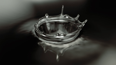 Slow motion Water drop collision with water surface forming beautiful crown