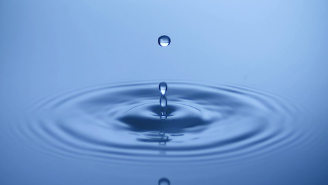 Slow motion Water drop splash into calm water