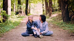 Romantic Young Couple Sitting Together In Forest And Enjoying … [135862608] | 写真素材・ストックフォトのアフロ