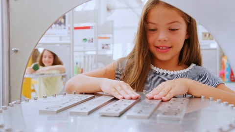 Four young kids do practical experiments at a science centre