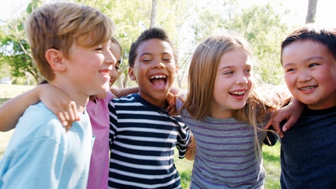 Portrait Of Group Of Children With Friends In Park Shot In Slow Motion