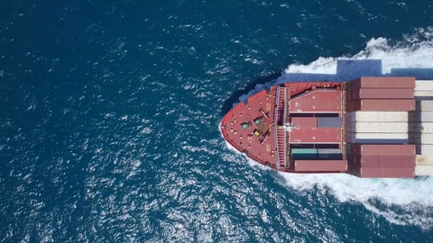 Aerial footage of a container ship roaring across the East Mediterranean Sea.